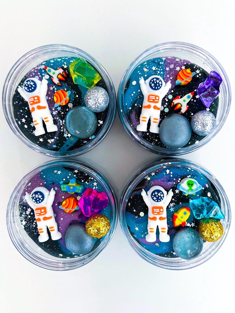 Outer Space Play Dough Kit with astronaut figure, swirled galaxy dough, gems, and charms. Fun kids activity for sensory play, space birthday parties, galaxy party favors, and astronaut themed celebrations. Perfect kids birthday gift, sensory toy, or party favor jar for creative play and outer space décor