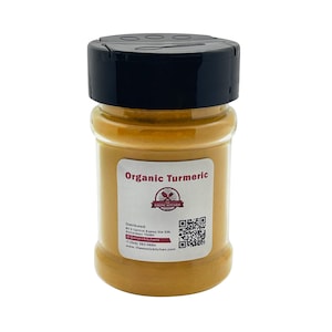 May include: A glass jar filled with bright yellow organic turmeric powder. The jar has a black lid and a white label with the text "Organic Turmeric" and a logo for "Exotic Kitchen". The label also includes contact information and a QR code.