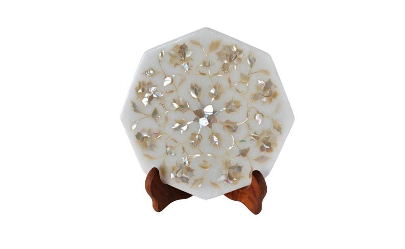 May include: White marble octagonal tray with a floral design inlaid with mother of pearl. The tray is on a wooden stand.