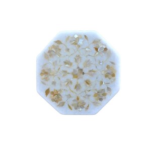 May include: Octagonal white marble table top with a floral design inlaid with mother of pearl and gold accents.