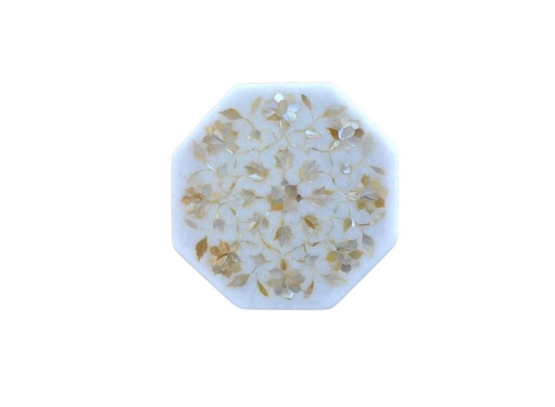 May include: Octagonal white marble table top with a floral design inlaid with mother of pearl and gold accents.
