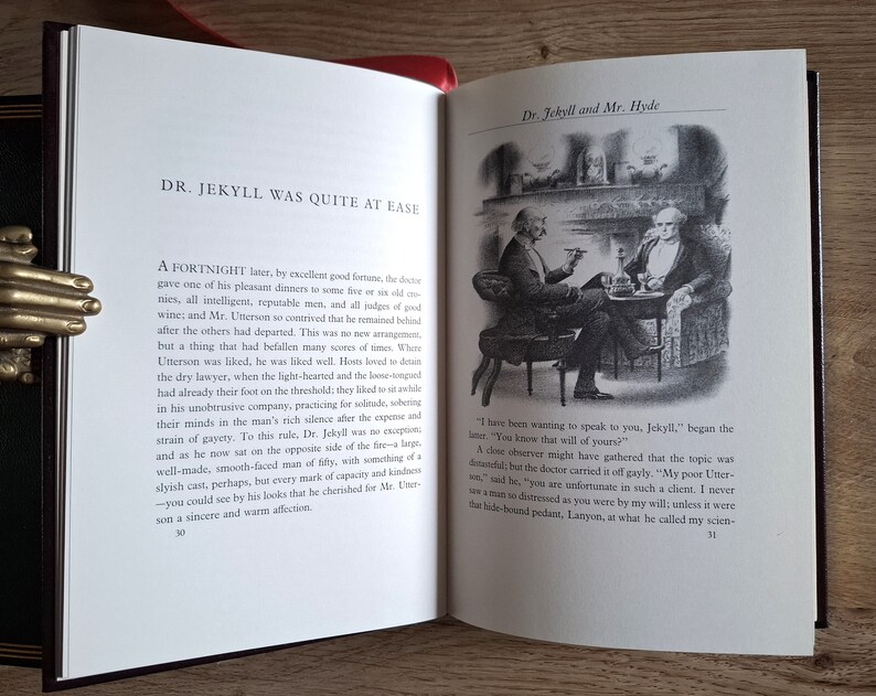 Pu&ograve; includere: Un'illustrazione in bianco e nero di due uomini seduti su sedie vicino a un camino. Il testo "Dr. Jekyll and Mr. Hyde" &egrave; in cima all'immagine. Il testo "DR. JEKYLL WAS QUITE AT EASE" &egrave; in cima alla pagina sinistra. Il testo "A FORTNIGHT later, by excellent good fortune, the doctor gave one of his pleasant dinners to some five or six old cronies, all intelligent, reputable men, and all judges of good wine; and Mr. Utterson so contrived that he remained behind after the others had departed. This was no new arrangement, but a thing that had befallen many scores of times. Where Utterson was liked, he was liked well. Hosts loved to detain the dry lawyer, when the light-hearted and the loose-womped had already their foot on the threshold; they liked to sit awhile in his unobtrusive company, practicing for solitude, sobering their minds in the man's rich silence after the expense and strain of gayety. To this rule, Dr. Jekyll was no exception, and as he now sat on the opposite side of the fire - a large, well-made, smooth-faced man of fifty, with something of a slyish cast, perhaps, but every mark of capacity and kindness - you could see by his looks that he cherished for Mr. Utterson a sincere and warm affection." &egrave; sulla pagina sinistra. Il testo "I have been wanting to speak to you, Jekyll," began the lawyer. "You know that will of yours?" &egrave; sulla pagina destra.
