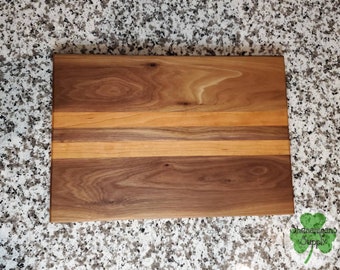 Walnut and cherry hardwood charcuterie cheese board/serving tray with non-marring feet.