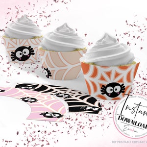 May include: Printable cupcake wrappers with a spider web design in pink, orange, and black. The wrappers feature a cute cartoon spider with googly eyes. The text "Instant Download" is visible in the image.