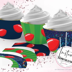 May include: Cupcakes with white frosting in decorative football-themed wrappers. The wrappers feature red footballs on navy, green, and a speckled blue background. Additional wrappers are displayed below, with a stadium design.