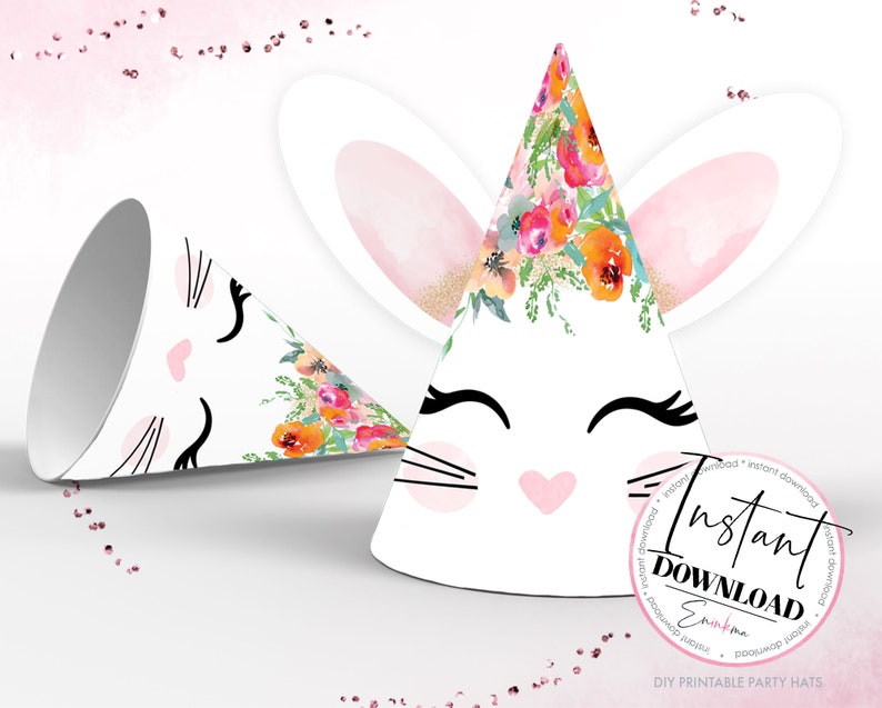 May include: White party hats with bunny face designs. One hat is upright, and the other is lying on its side. The hats feature black eyelashes, pink noses, and floral accents. The hats have the text "Instant Download" and "DIY Printable Party Hats".