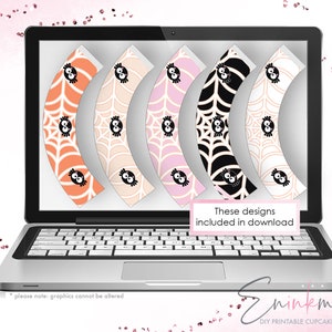 May include: A laptop screen displaying five different cupcake wrapper designs featuring a spider web pattern with black spiders. The text "These designs included in download" is displayed on the screen. The text "ninkma DIY PRINTABLE CUPCAKE WRAPPERS" is displayed below the laptop.
