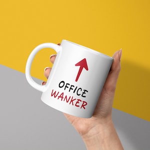 May include: White ceramic mug with a red arrow pointing upwards and the text "OFFICE WANKER" in black.