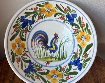 May include: A white ceramic bowl with a blue, yellow, and green floral design and a rooster in the center.