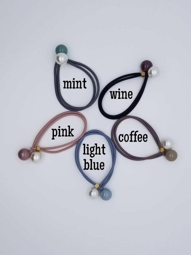 May include: Five hair ties with pearl and colored beads. The colors are mint, wine, pink, light blue, and coffee.