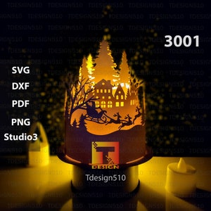 May include: A laser cut design of a Christmas scene with Santa Claus in a sleigh pulled by reindeer flying over a village with a house and trees. The design is lit from behind with a candle, creating a warm glow. The design is available in SVG, DXF, PDF, PNG, and Studio3 formats. Tdesign510.