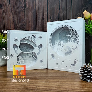 May include: Two white, layered paper art pieces. One features a snowman with a hat and mittens, snowflakes, and a winter scene. The other depicts a spooky Halloween scene with ghosts and a swirling spiral. The brand name "Tdesign510" is visible.