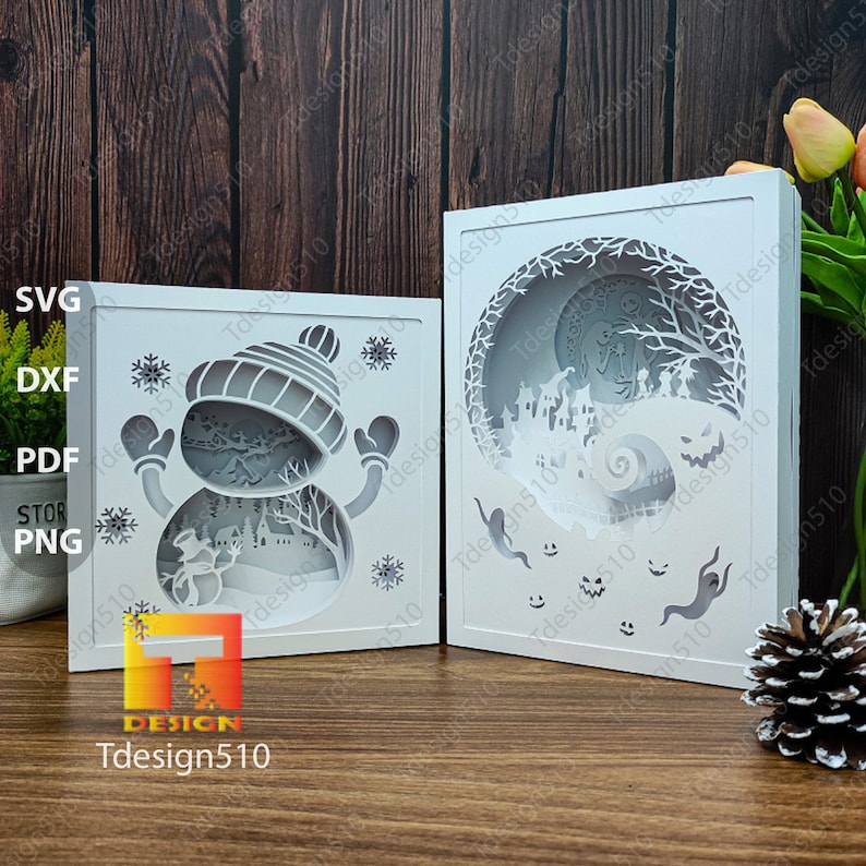 May include: Two white, layered paper art pieces. One features a snowman with a hat and mittens, snowflakes, and a winter scene. The other depicts a spooky Halloween scene with ghosts and a swirling spiral. The brand name "Tdesign510" is visible.