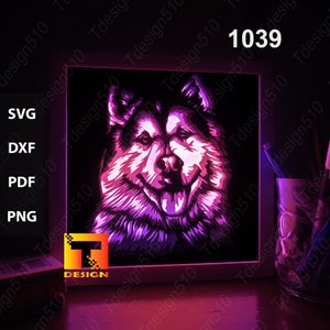 May include: A digital art illustration of a dog's face in shades of purple and pink. The dog has a long snout, floppy ears, and a pink tongue sticking out. The image is framed in a white frame and is lit up with a pink glow.