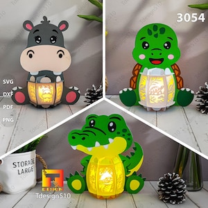 May include: Three animal-shaped light-up lanterns: a hippo, a turtle, and an alligator. Each lantern has a detailed cutout design that emits light. The hippo is gray, the turtle is green, and the alligator is green and yellow. The image also includes the text "SVG, DXF, PDF, PNG".