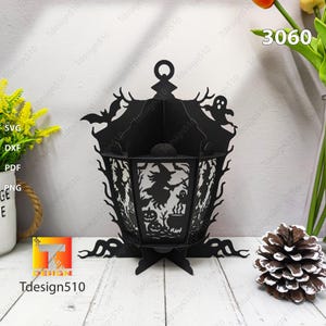 May include: Black Halloween lantern with a witch, bats, and ghosts cut-out design. The lantern has a handle and a base. The text "Tdesign510" is visible. The number "3060" is also visible.