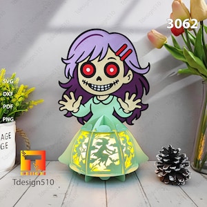 May include: A Halloween paper lantern depicting a cartoon girl with purple hair, red eyes, and a skeletal grin. The lantern's base is light green, with a witch silhouette. The number "3062" is visible.