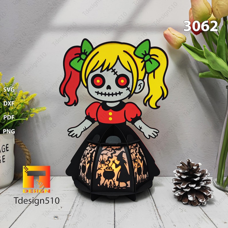 May include: A Halloween lantern with a cartoon zombie girl design. The girl has yellow hair, red eyes, and a black dress. The lantern has a black frame with a witch silhouette design. The number 3062 is visible.