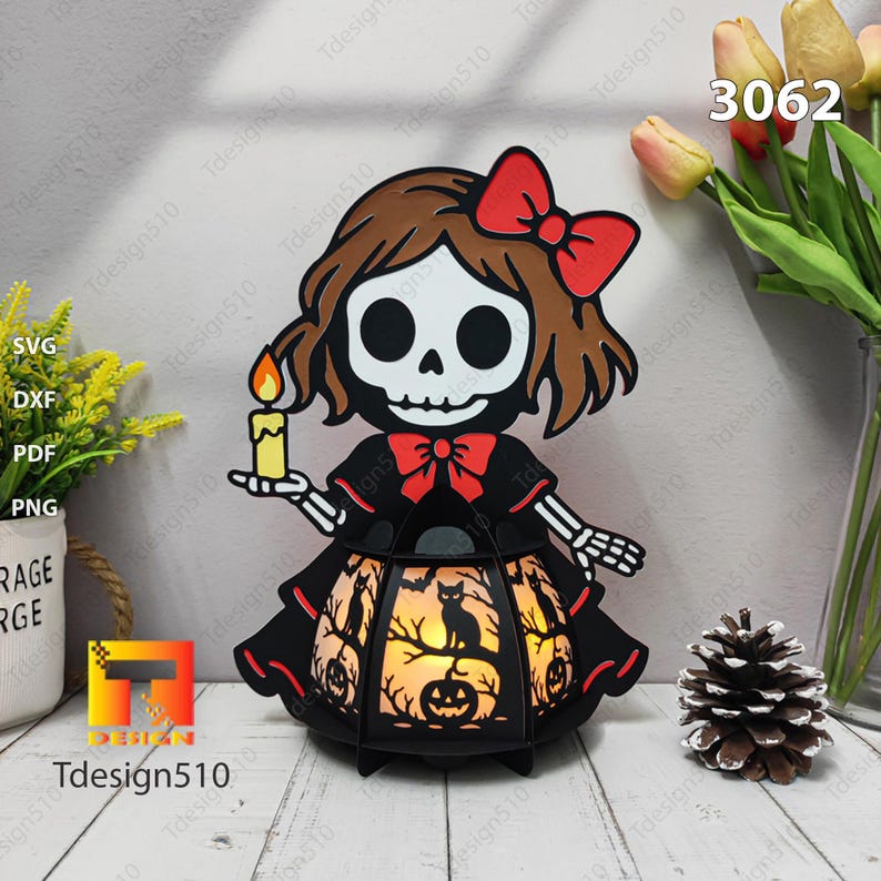 May include: A Halloween lantern with a skeleton girl design. The black lantern has cut-out designs of cats, pumpkins, and trees. The girl has a red bow and holds a candle. The image also includes the text "Tdesign510" and the number "3062".