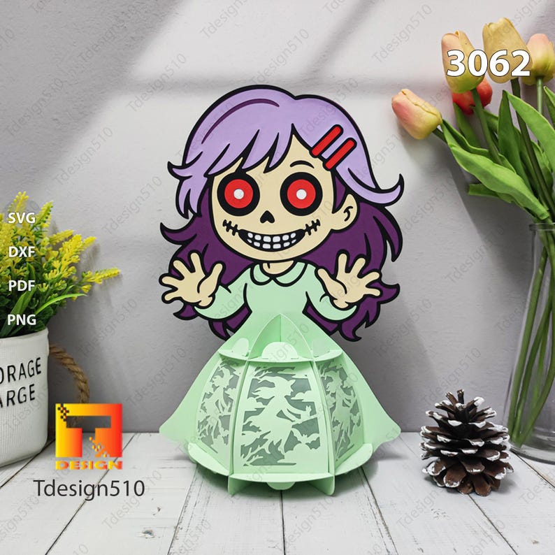 May include: A Halloween papercraft of a cartoon zombie girl with purple hair and red eyes, wearing a green dress. She stands before a light green lantern with a bat design. The image includes the text "Tdesign510" and the number "3062".