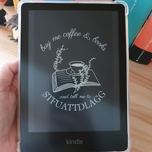 May include: A black and white illustration of a cup of coffee on a book with the text "buy me coffee & books and tell me to STFUATTDLAGG" on a Kindle e-reader.