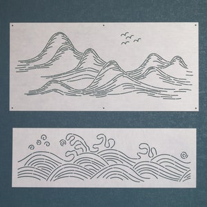 May include: Two metal wall decor pieces with a minimalist design. The top piece features a stylised mountain range with a flock of birds flying overhead. The bottom piece features a stylised wave pattern.