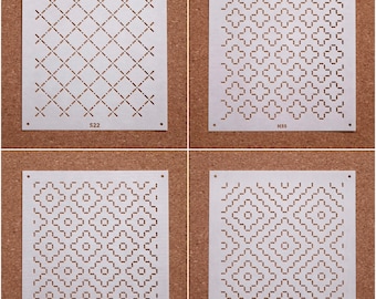 May include: Four white paper stencils with different geometric patterns. The stencils are labeled S22, H35, H37, and H32.