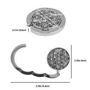 May include: A silver-colored purse hook with a decorative floral pattern. The hook is 3.70 inches (9.4 cm) long when open and 2.36 inches (6 cm) tall. The circular top is 1.73 inches (4.4 cm) in diameter and 0.31 inches (0.8 cm) thick.