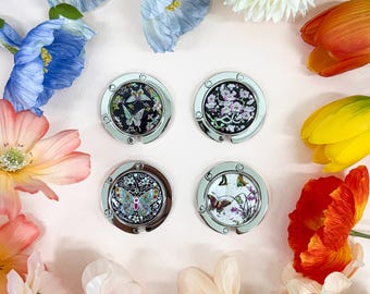 Gancho para bolso de nácar, percha plegable para bolso, tamaño portátil.