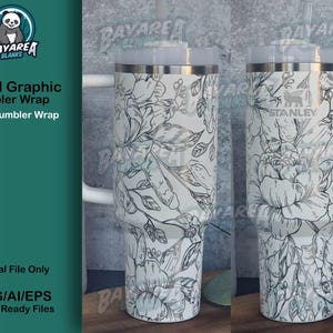 Puede incluir: Un vaso blanco de 40 onzas con un diseño gráfico floral negro. El vaso tiene una asa y una tapa. El texto "Floral Graphic Tumbler Wrap" y "40 Oz Tumbler Wrap" es visible en la imagen. El texto "BAYAREA BLANKS" también es visible en la imagen.