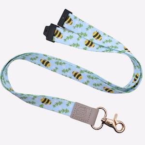 Cordón de tela con diseño de abejas y estampado de plantas azules con cierre de langosta