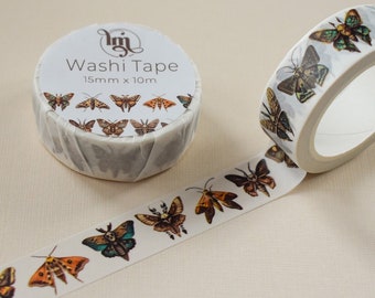 May include: White washi tape roll with a repeating pattern of colorful moths. The tape is labeled "Washi Tape" and measures 15mm x 10m. The moths are in shades of brown, orange, green, and blue.