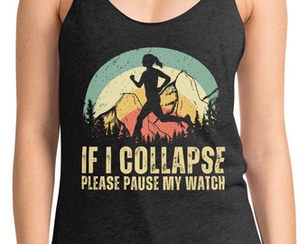 May include: A dark gray tank top with a vintage-style graphic of a woman running in front of a mountain range with the text "IF I COLLAPSE PLEASE PAUSE MY WATCH".