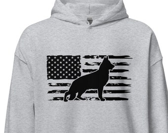 May include: A grey hooded sweatshirt featuring a black silhouette of a German Shepherd dog standing in front of a distressed American flag design.