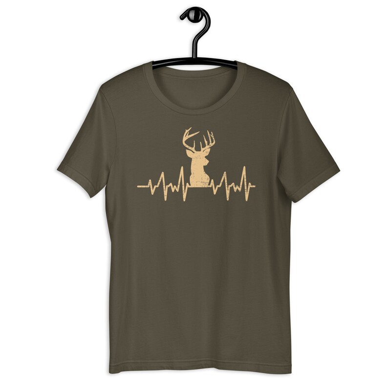 May include: A dark green t-shirt with a tan deer silhouette and a heartbeat graphic. The deer has large antlers.