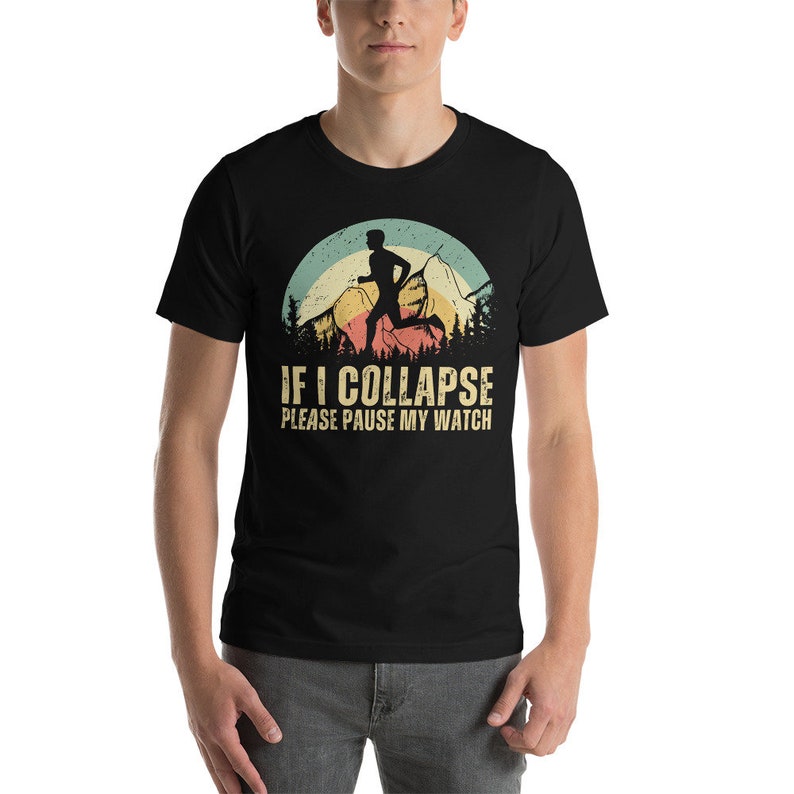 May include: Black t-shirt with a vintage-style graphic of a runner in front of a mountain range. The text "IF I COLLAPSE PLEASE PAUSE MY WATCH" is printed below the graphic.