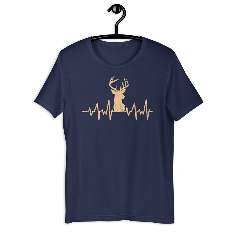 May include: Navy blue t-shirt with a distressed brown deer silhouette and a heartbeat graphic.