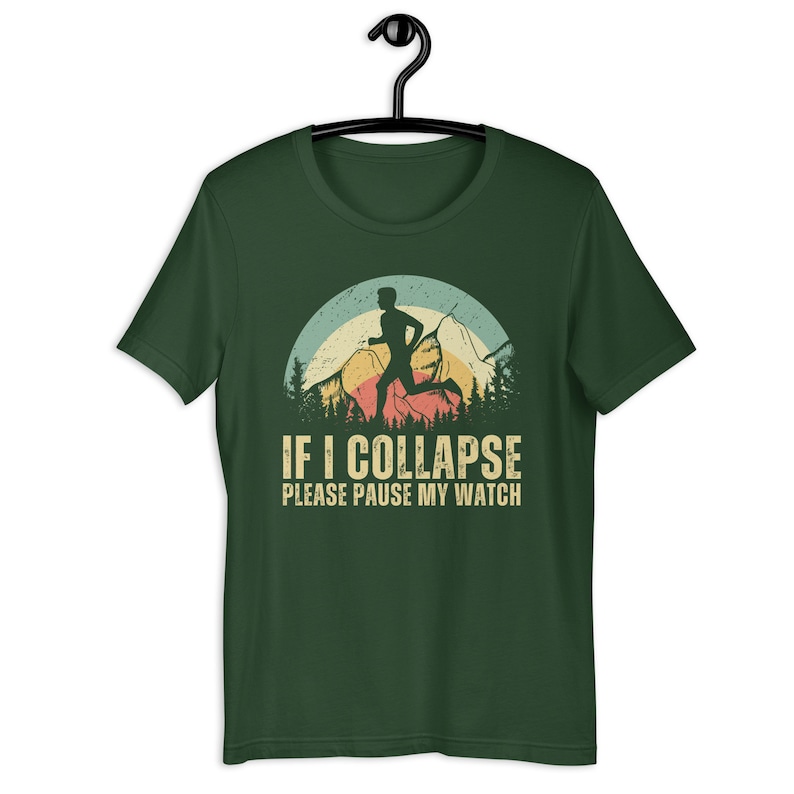 May include: Green t-shirt with a vintage-style graphic of a runner in front of mountains. The text "IF I COLLAPSE PLEASE PAUSE MY WATCH" is printed below the graphic.
