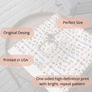 May include: White wrapping paper with a repeating pattern of colorful Colombian-themed illustrations and the word "Colombia". A wrapped gift is centered on the paper, tied with a gray ribbon. The text "Printed in USA" is visible.