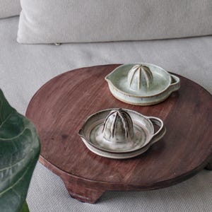 May include: A rustic wooden sign with the text "Welcome to our home" in white lettering. The sign features a distressed finish and a simple, inviting design, perfect for front door decor.