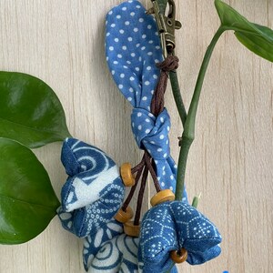 Small blue cotton fabric flowers keychain.