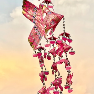 Thai pink fish mobile weaved with palm leaves painted bright pink. It’s a handmade weave work as a decoration.