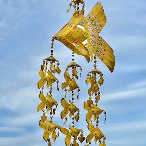 Thai yellow fish mobile weaved with palm leaves painted bright gold . It’s a handmade weave work as a decoration.
