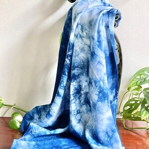 Der Schal ist aus weißer Baumwolle. Mit der blauen Tie-Dye-Technik