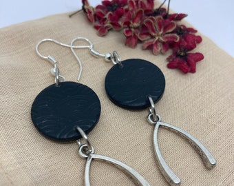 Dangling black textured earrings and silver charms in the shape of a bone, stainless steel clips anti allergy, unique model