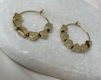Pair of golden beaded heart hoop earrings