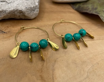 Pair of hoop earrings with green marbled beads and golden brass