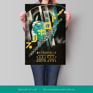 May include: A black and white poster with a stylized image of a person's face. The poster is for the film "Metropolis" and features Japanese text. The poster is 20 inches by 30 inches.