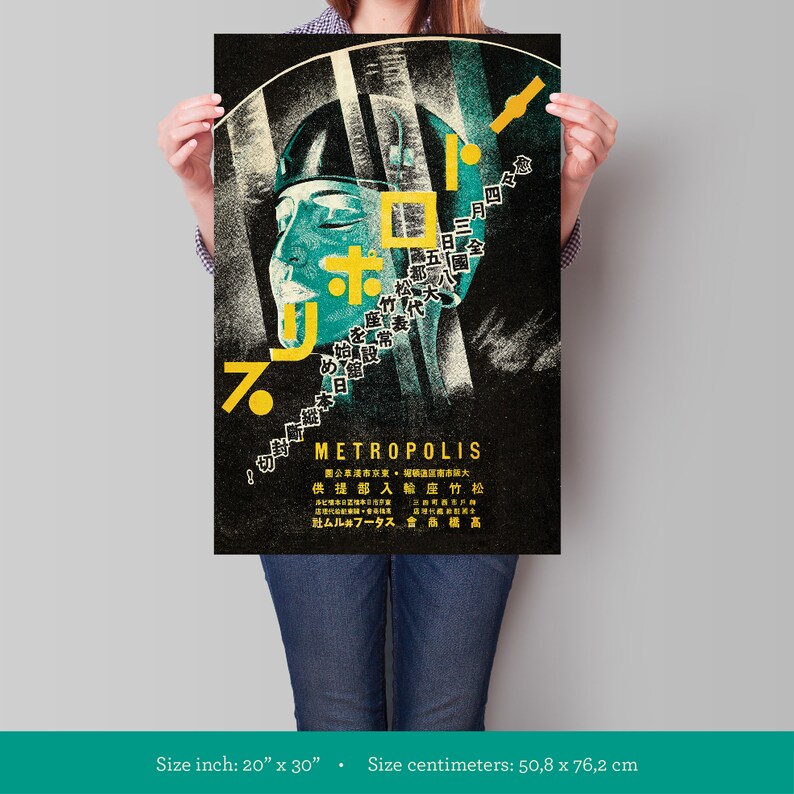 May include: A black and white poster with a stylized image of a person's face. The poster is for the film "Metropolis" and features Japanese text. The poster is 20 inches by 30 inches.