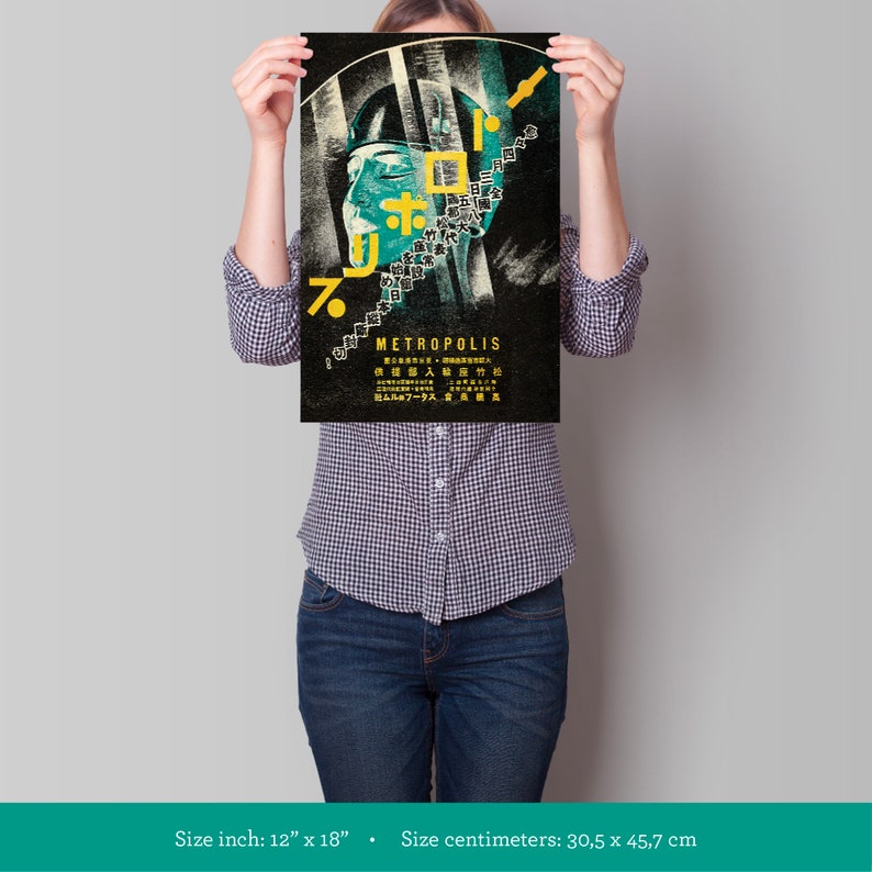 May include: A vintage style poster for the film Metropolis, featuring a woman's face with Japanese text and the title "METROPOLIS" in yellow lettering. The poster is 12 inches by 18 inches.